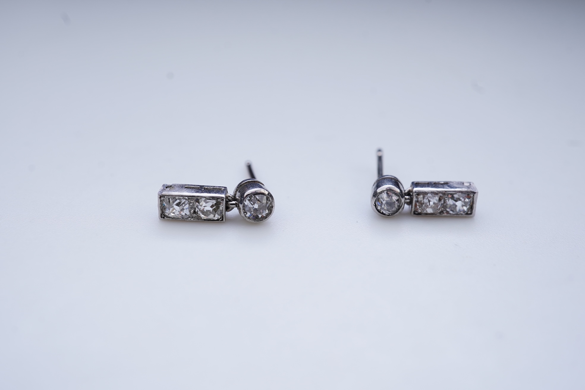 A pair of diamond earrings, early 20th century composite